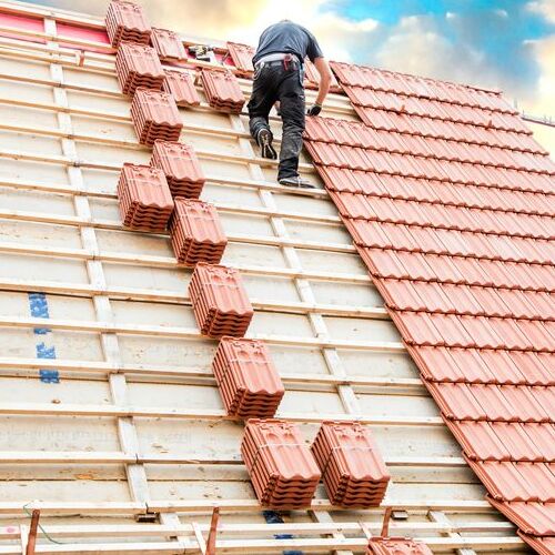 A Roofer Installs Ceramic Tiles