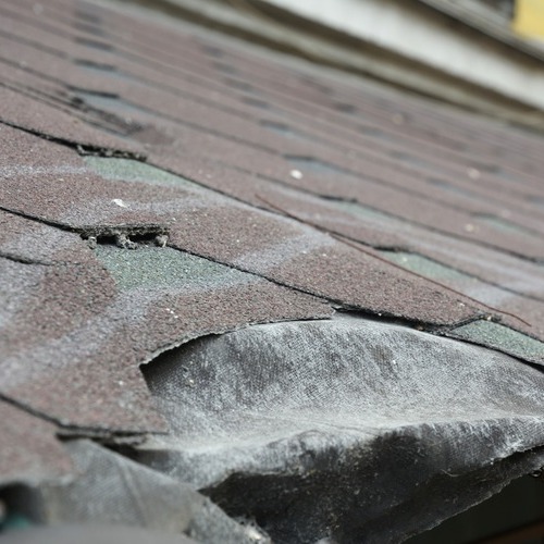 close-up of damaged asphalt shingle roofing