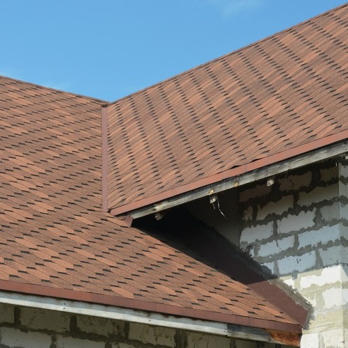 home with a brown asphalt shingle roof