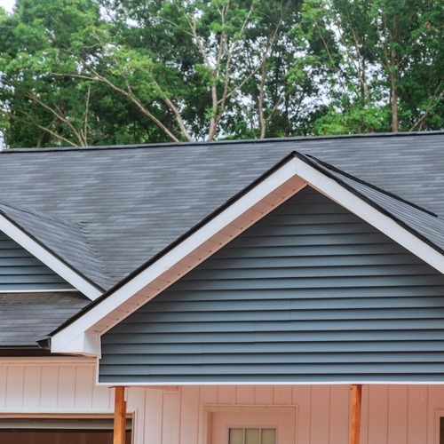 brick home with a shingle roof
