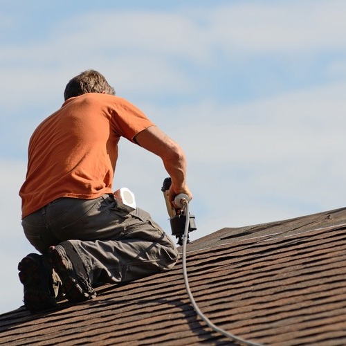 A Roofer Replaces Shingles.