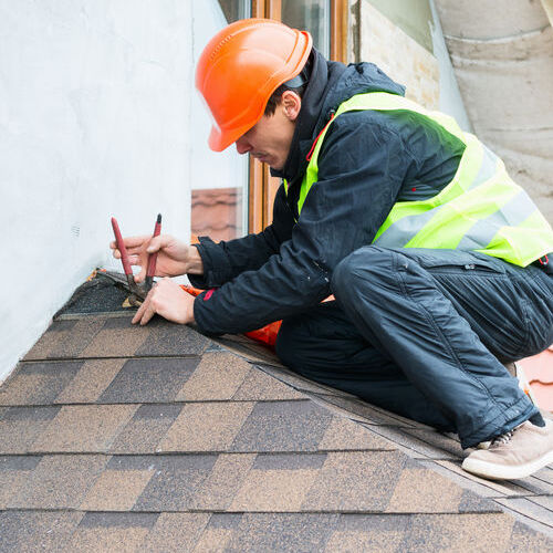 A Roofer Repairs Asphalt Shingles.