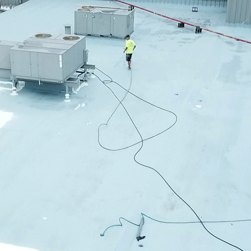 A Roofer Applies a Silicone Roof Coating