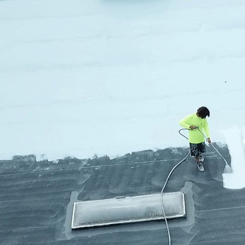 A Roofer Applies Elastomeric Roofing
