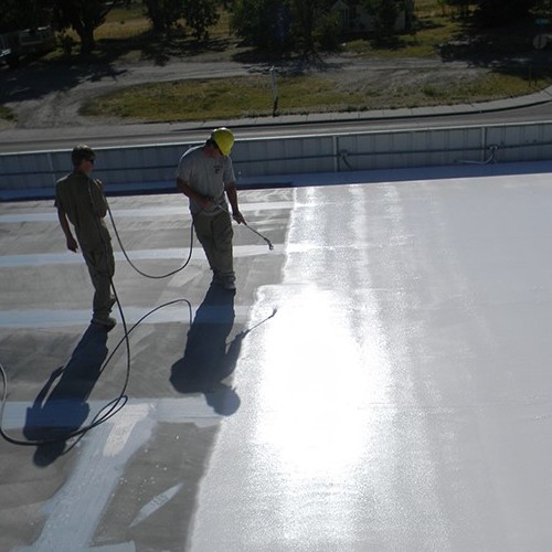 Contractors Spray a Roof Restoration Coating.