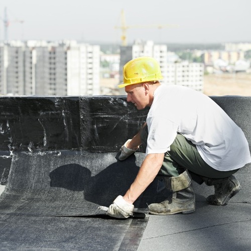 A Roofer Installs Modified Bitumen Roofing
